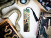 a bookmark, snake, and other items on a table