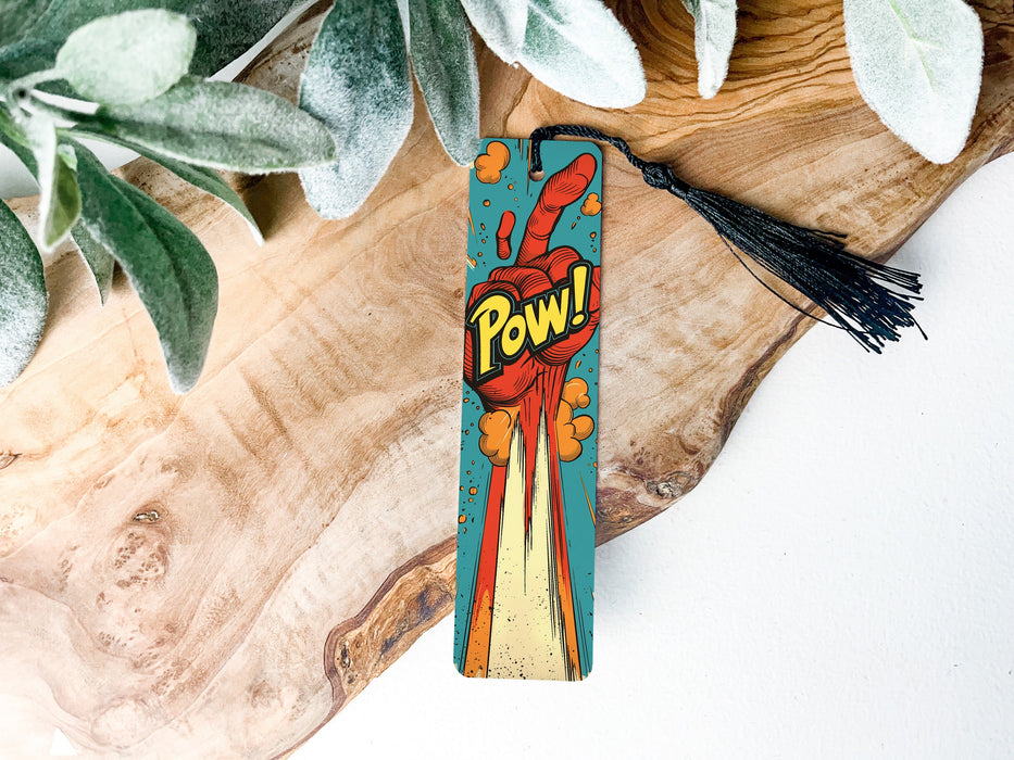a wooden piece of art with a tassel on top of it