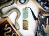 a bookmark with a snake on it next to other books