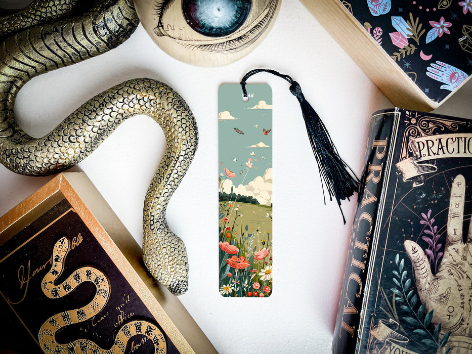 a bookmark with a snake on it next to other books