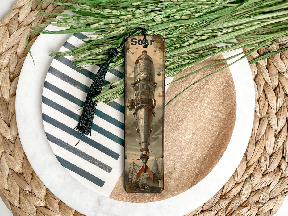 a bookmark with a tassel on top of a plate