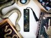 a bookmark, snake, and other items on a table