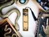 a bookmark with a snake on it next to other books