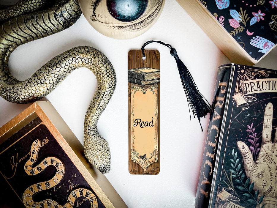 a bookmark with a snake on it next to other books