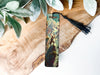a bookmark with a picture of a forest on it