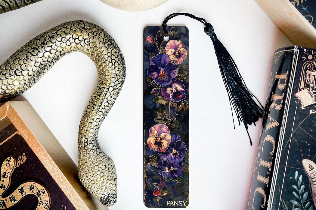 a bookmark with a snake and flowers on it