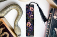a bookmark with a snake and flowers on it
