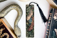 a bookmark with a picture of a woman and a snake on it