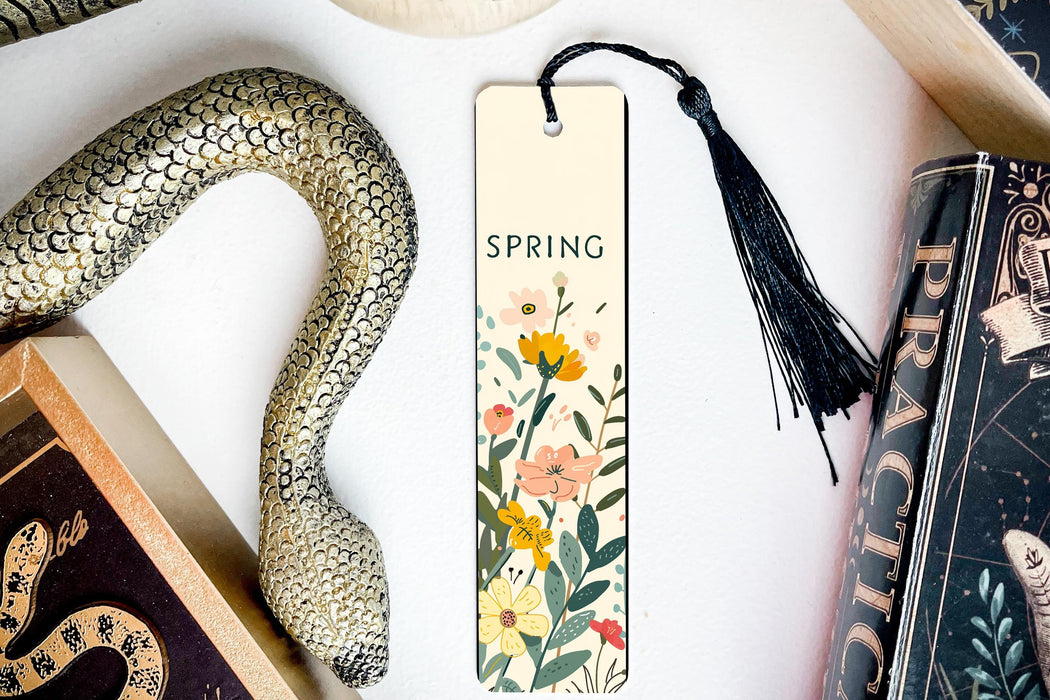 a bookmark with a snake and flowers on it