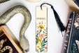 a bookmark with a snake and flowers on it