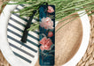 a bookmark with flowers on it sitting on a plate