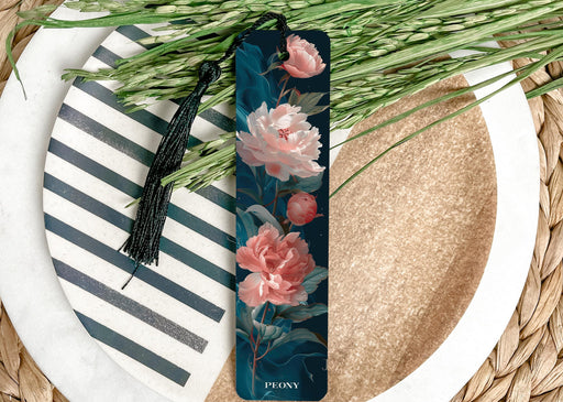 a bookmark with flowers on it sitting on a plate