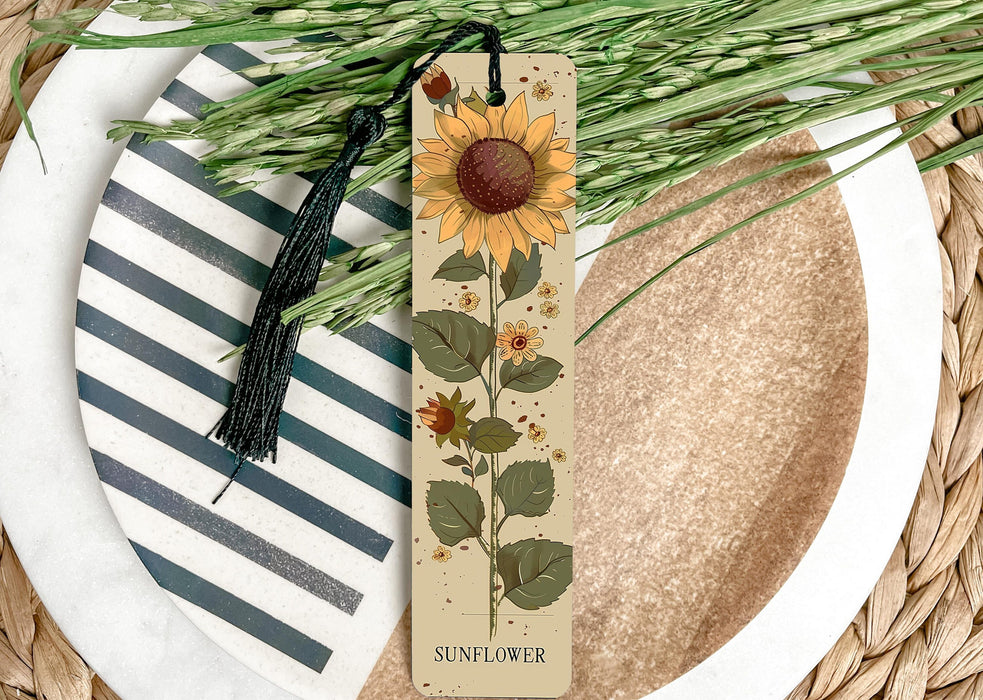 a bookmark with a sunflower on it sitting on a plate