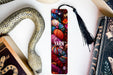 a bookmark with yarn and a snake next to it