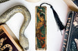 a bookmark with a picture of a woman and a snake on it