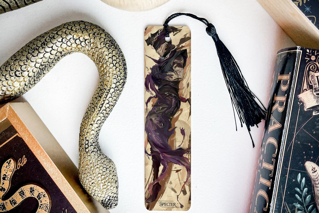 a bookmark, snake, and other items on a table