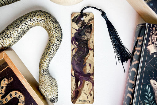 a bookmark, snake, and other items on a table