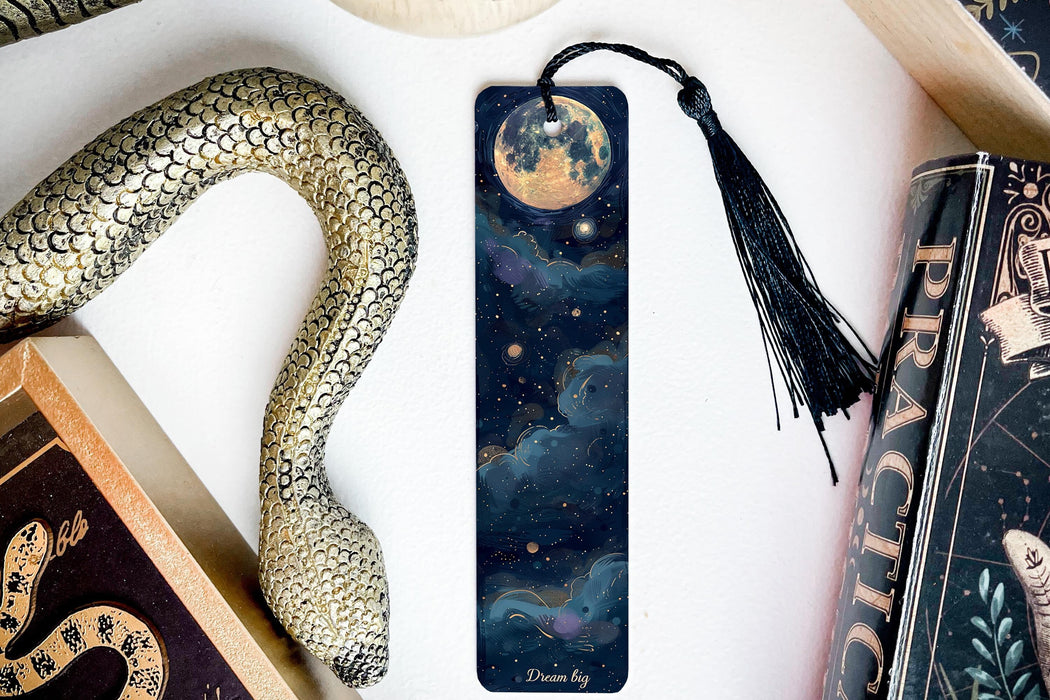 a bookmark with an image of a snake and a full moon