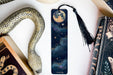 a bookmark with an image of a snake and a full moon