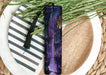 a purple bookmark sitting on top of a white plate