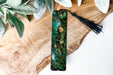a green bookmark with a picture of a woman on it