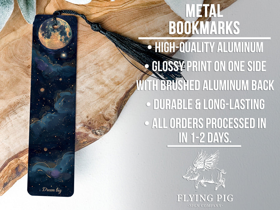 a metal bookmark with an image of the moon and stars on it