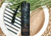 a bookmark with a picture of a path in the woods