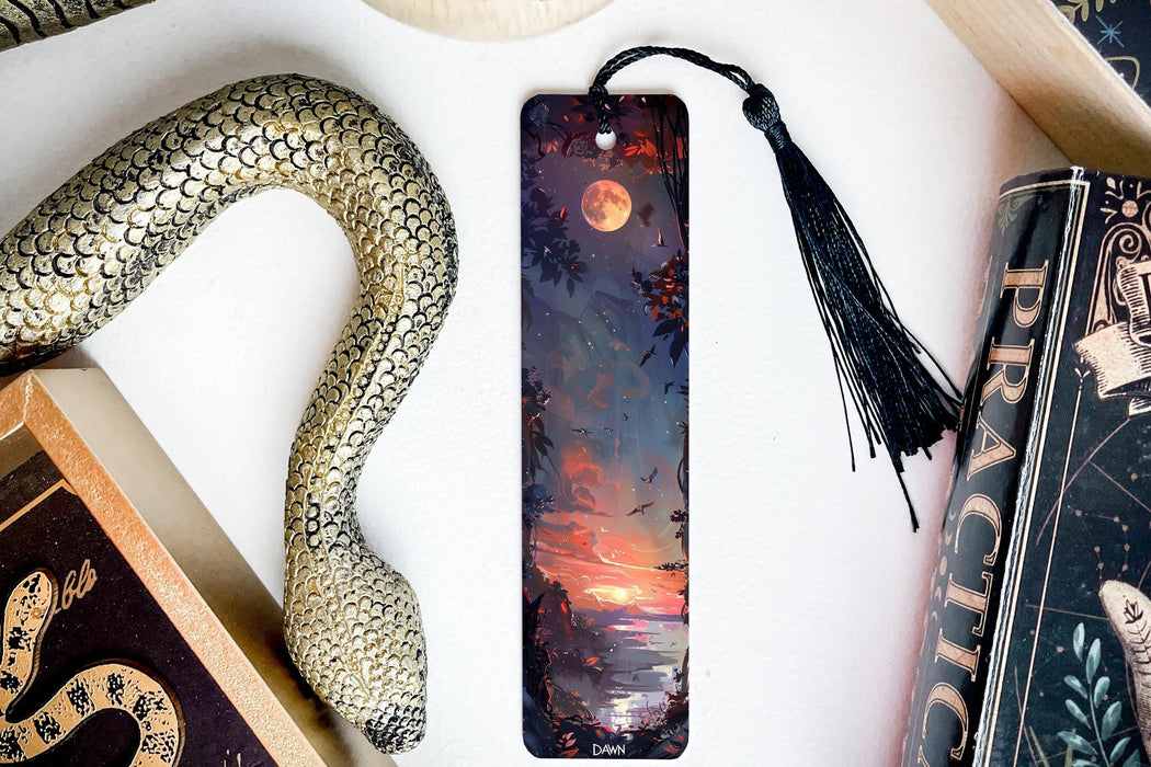 a bookmark with a painting of a sunset and a snake