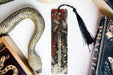 a bookmark with a picture of a man and a snake on it