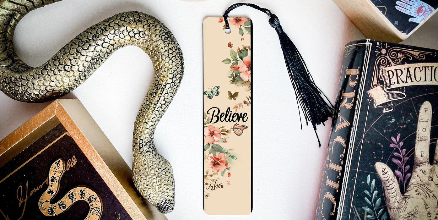 a bookmark with a snake on it next to other books
