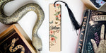 a bookmark with a snake on it next to other books