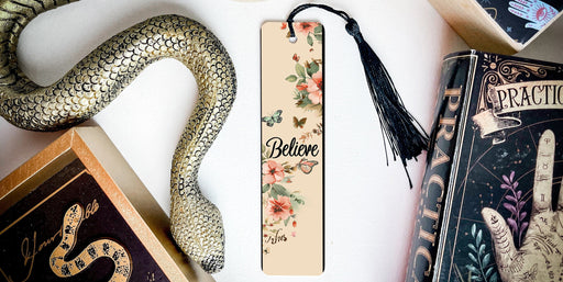 a bookmark with a snake on it next to other books