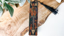 a wooden clock with a tassel hanging from it's side