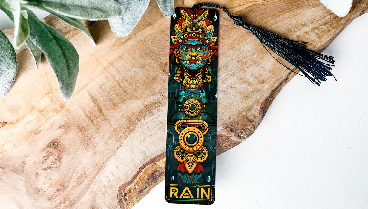 a bookmark with a tassel on top of a piece of wood