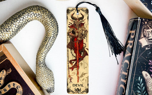 a bookmark, snake, and other books on a table