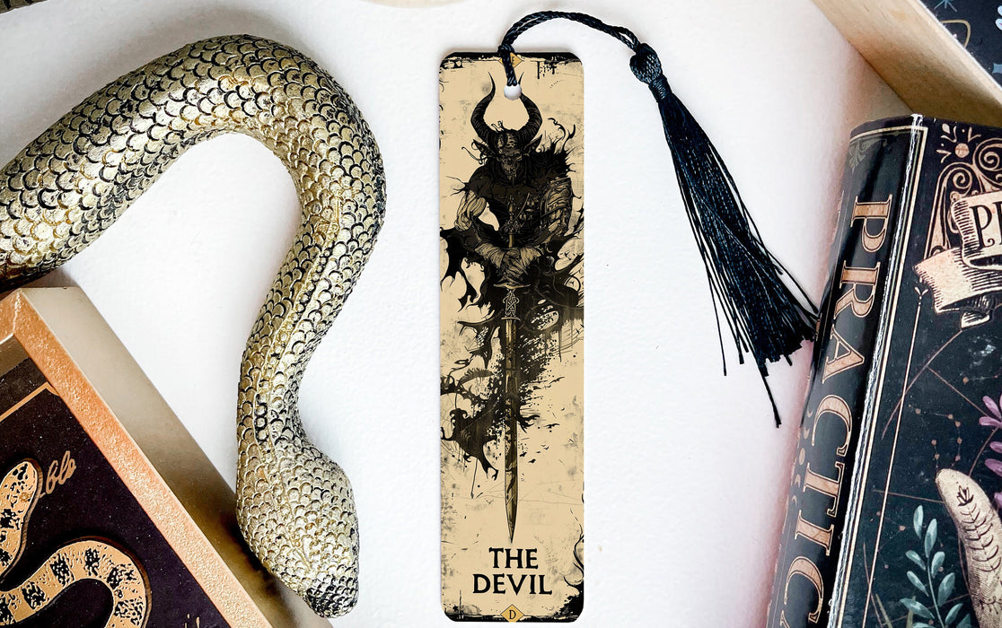 a bookmark with a dragon on it next to other books
