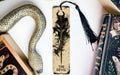 a bookmark with a dragon on it next to other books