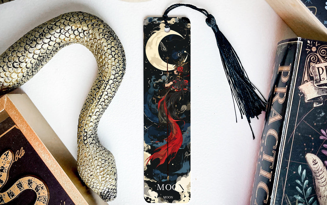 a bookmark with a snake and a book on it