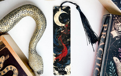 a bookmark with a snake and a book on it