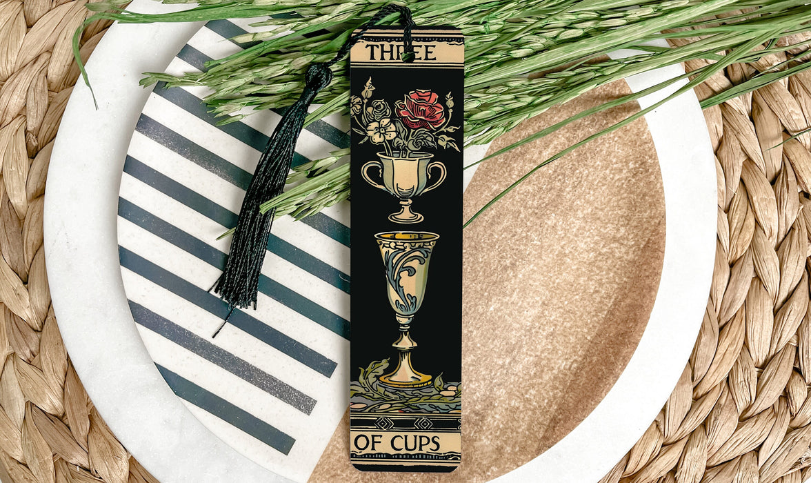 a bookmark with a tassel on top of a plate