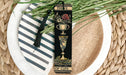 a bookmark with a tassel on top of a plate