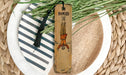 a wooden bookmark with a tassel on top of it