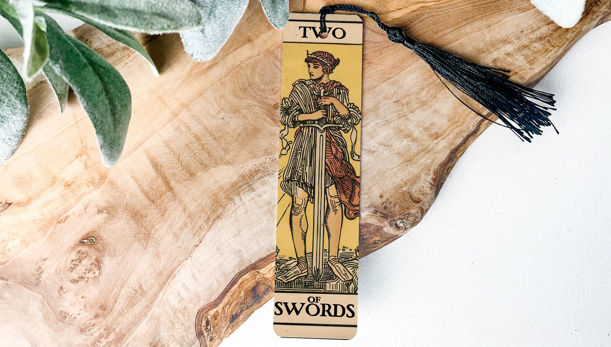 a wooden bookmark with a picture of a man holding a sword