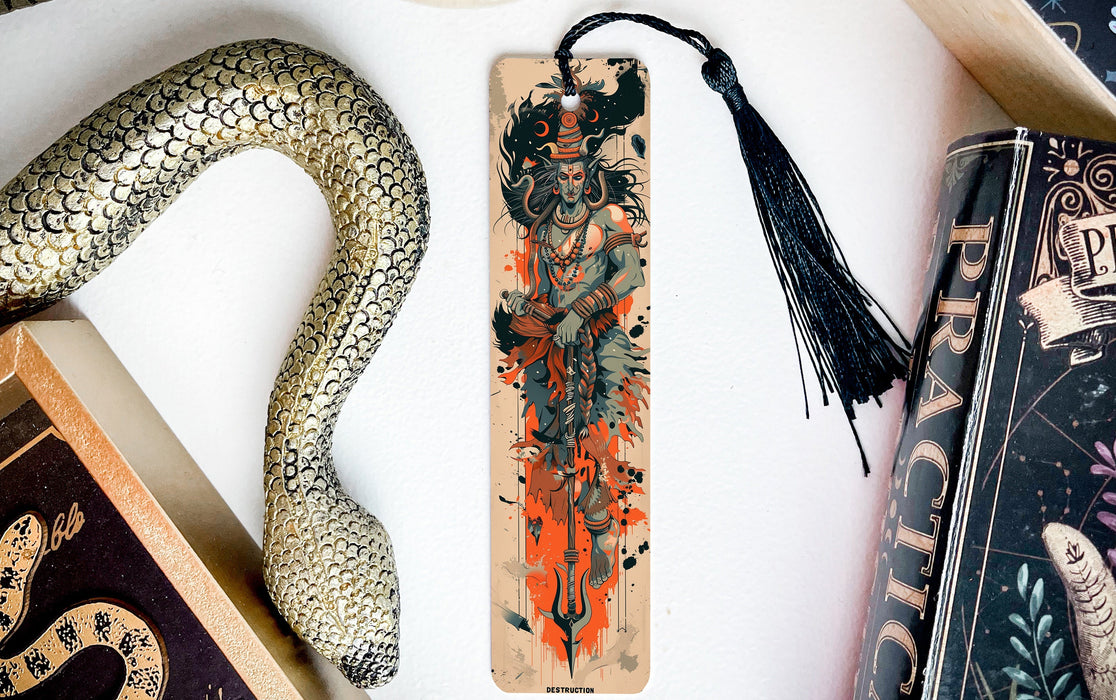 a snake, a bookmark, and two books on a table