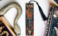 a snake, a bookmark, and some books on a table