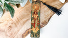 a wooden cross with a tassel hanging from it