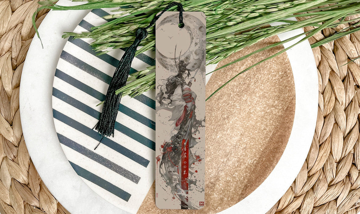 a white plate topped with a bookmark next to a plant