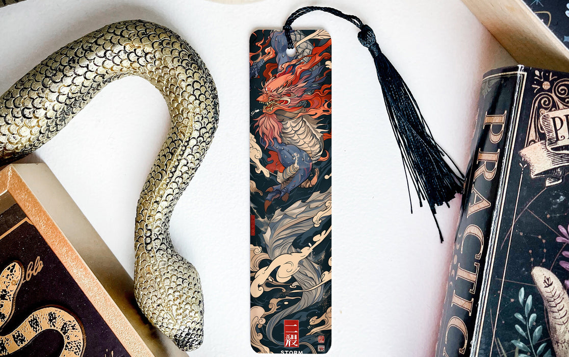 a bookmark with a snake on it next to books