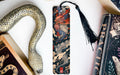a bookmark with a snake on it next to books