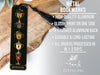 a metal bookmark with a tassel hanging from it